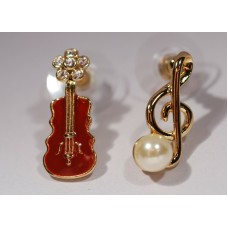 Different earrings: violin and G clef. Golden color